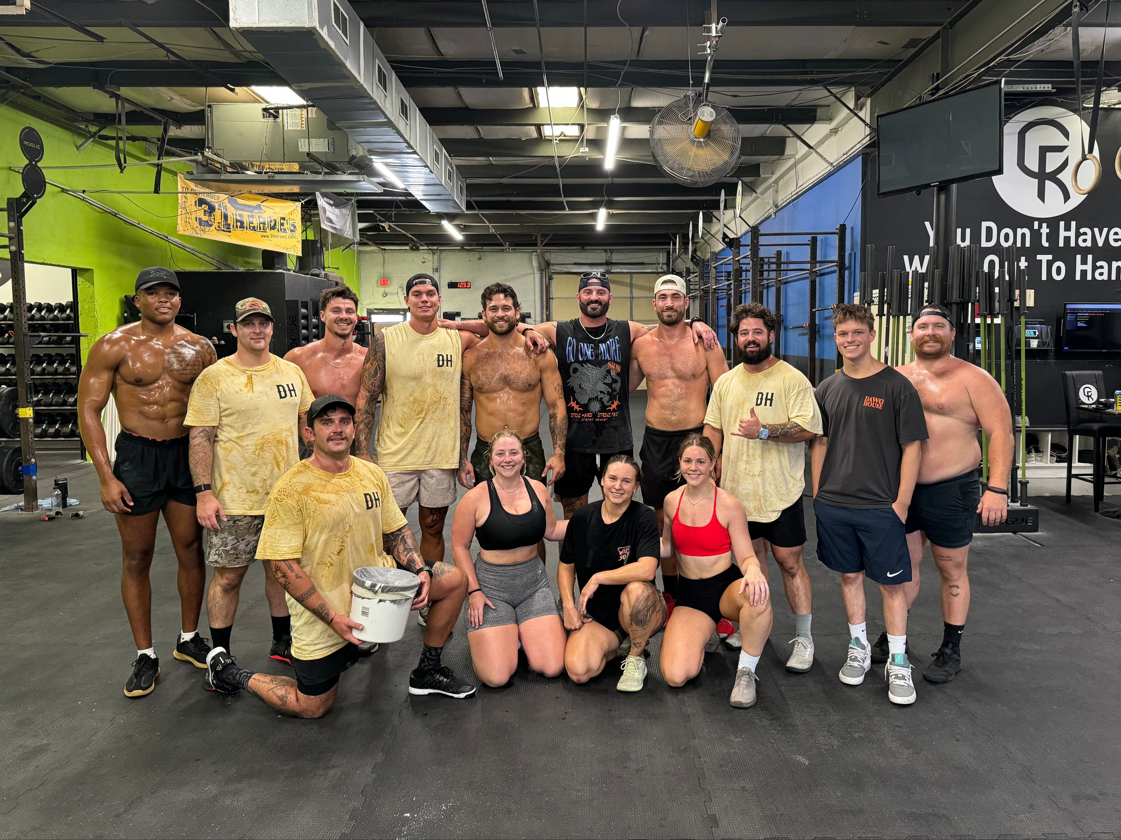 Group of people posing together in a gym setting